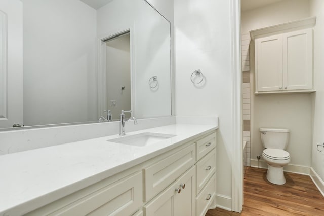 bathroom featuring vanity, toilet, and hardwood / wood-style floors