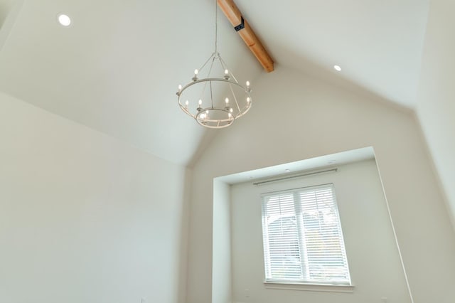 room details featuring an inviting chandelier and beamed ceiling