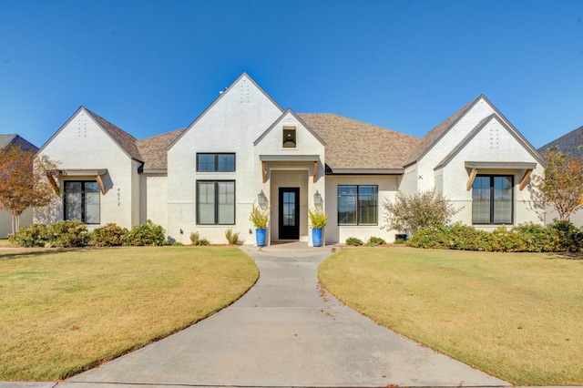 french country style house with a front yard