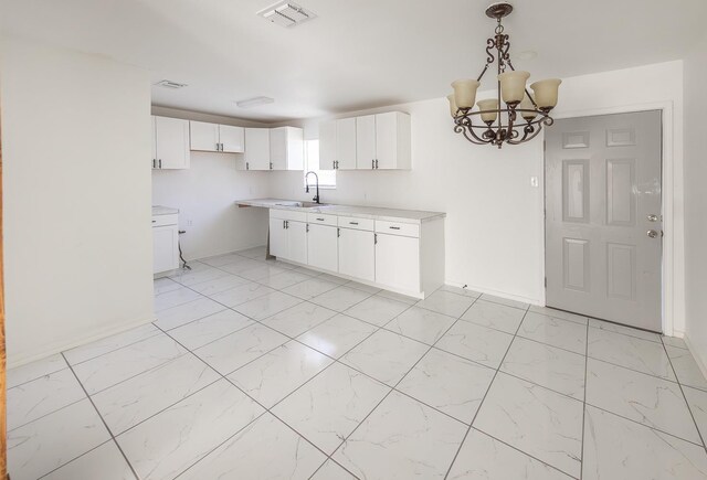 2004 Date Ave, Lubbock, TX 79404 - kitchen featuring hanging light fixtures, sink, white cabinets, and an inviting chandelier
