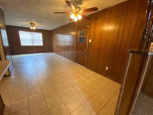 empty room with wooden walls and ceiling fan