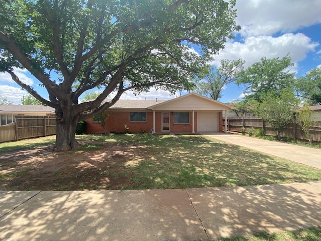 ranch-style house featuring a garage and a front yard