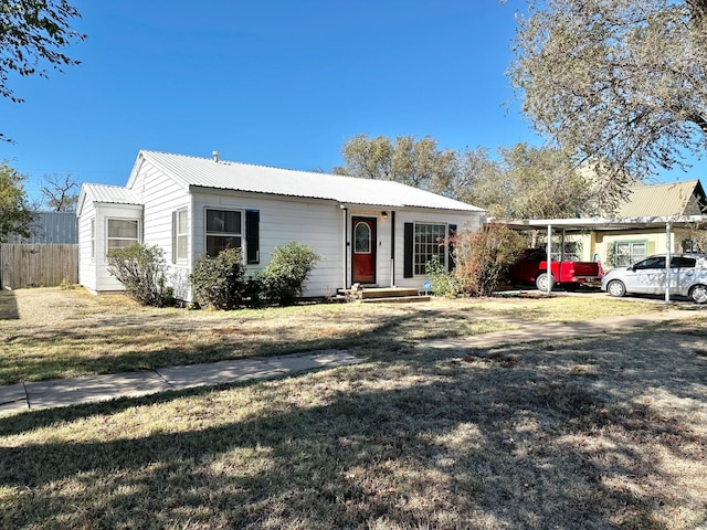 ranch-style house featuring a front yard and a carport