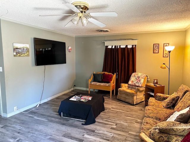 living room featuring crown molding, hardwood / wood-style floors, a textured ceiling, and ceiling fan