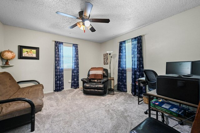 office area with carpet, a textured ceiling, and ceiling fan