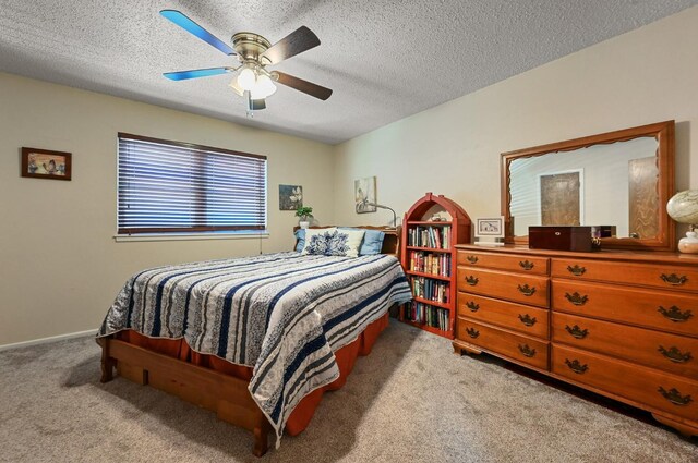 bedroom featuring ceiling fan, a textured ceiling, and carpet