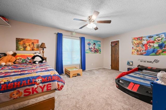 bedroom with a textured ceiling, light colored carpet, and ceiling fan