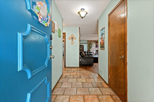 hallway featuring a textured ceiling