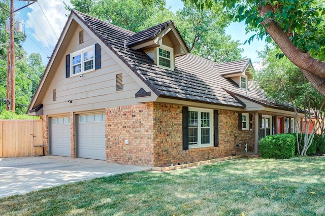 view of front of property featuring a garage, a front yard, concrete driveway, and brick siding