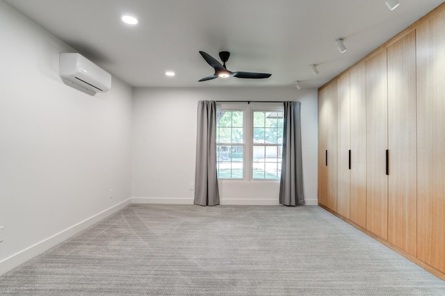 interior space featuring light carpet, baseboards, ceiling fan, an AC wall unit, and recessed lighting