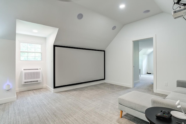 home theater featuring light colored carpet, vaulted ceiling, baseboards, and a wall mounted AC