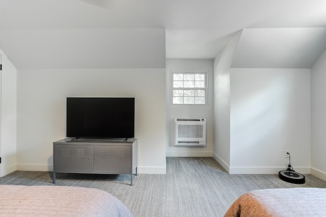 bedroom with an AC wall unit, light colored carpet, and baseboards