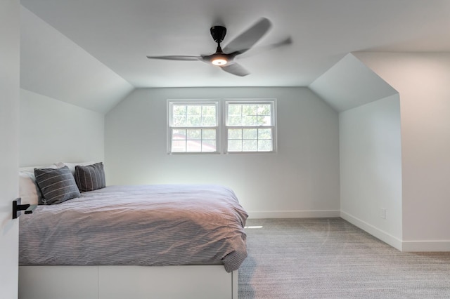 bedroom with light carpet, baseboards, and lofted ceiling