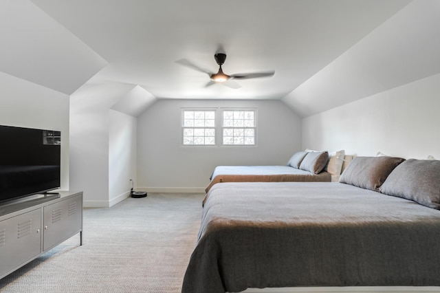 bedroom with light carpet, lofted ceiling, a ceiling fan, and baseboards