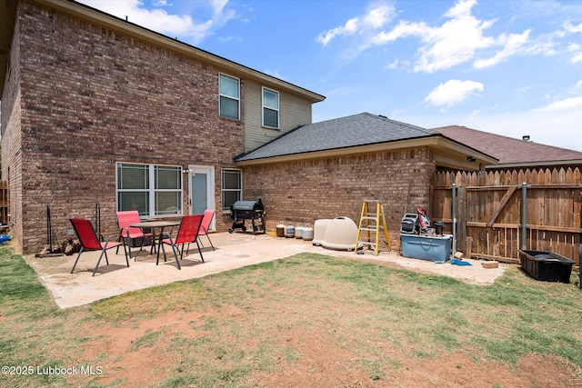 10827 Detroit Ave, Lubbock, TX 79423 - rear view of property featuring brick siding, a patio area, and a shingled roof