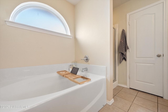 10827 Detroit Ave, Lubbock, TX 79423 - full bathroom featuring tile patterned floors, a garden tub, a stall shower, and baseboards