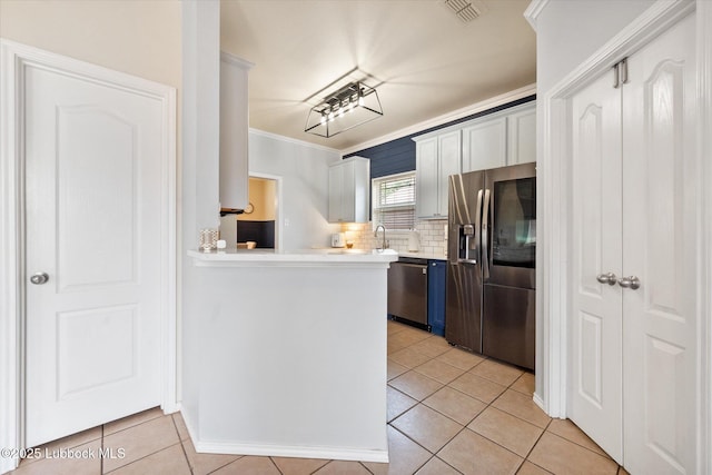 10827 Detroit Ave, Lubbock, TX 79423 - kitchen featuring appliances with stainless steel finishes, ornamental molding, light countertops, tasteful backsplash, and light tile patterned flooring