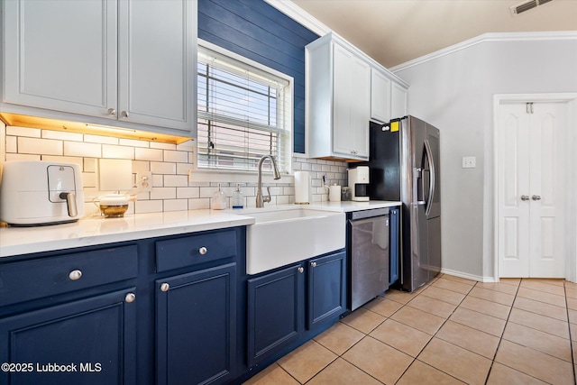 10827 Detroit Ave, Lubbock, TX 79423 - kitchen featuring blue cabinetry, a sink, ornamental molding, appliances with stainless steel finishes, and decorative backsplash