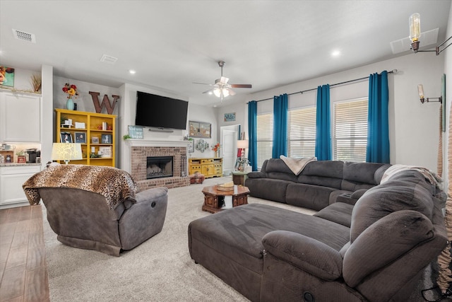 living area with recessed lighting, visible vents, and a ceiling fan