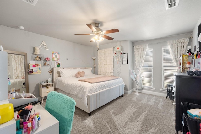 bedroom featuring baseboards, a ceiling fan, carpet flooring, and visible vents