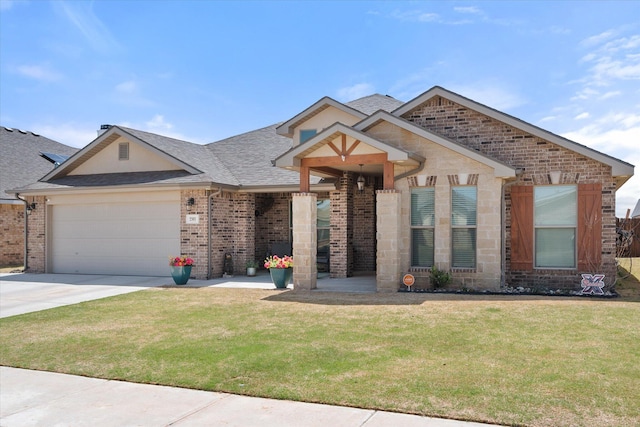 view of front of property with a garage, driveway, a front yard, brick siding, and roof with shingles