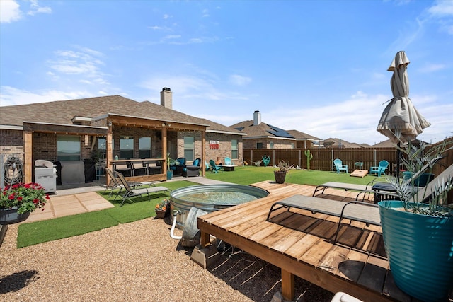 exterior space featuring a fenced backyard and a jacuzzi