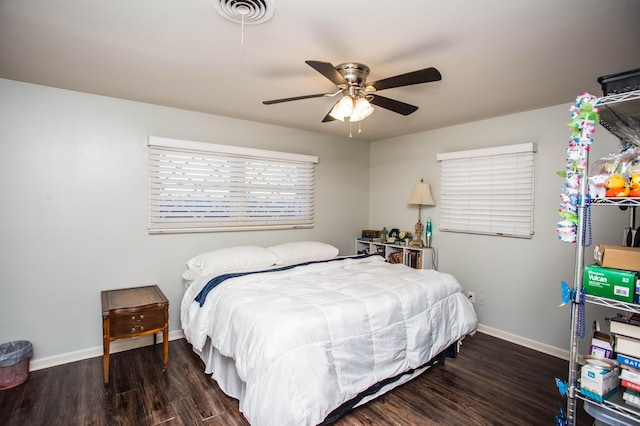 bedroom featuring baseboards, wood finished floors, visible vents, and a ceiling fan