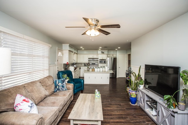 living room featuring a ceiling fan and dark wood finished floors