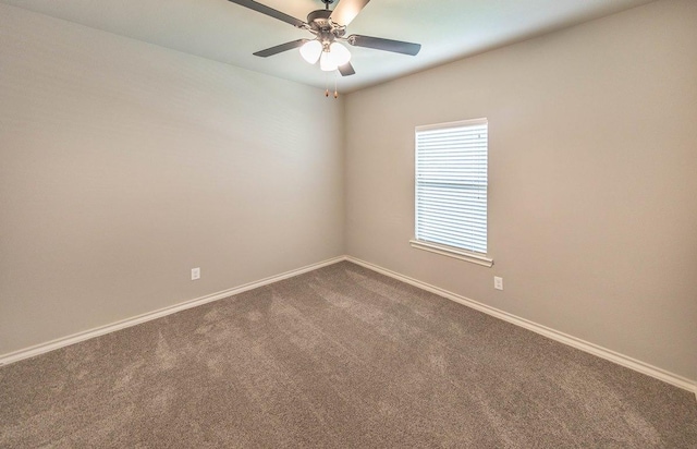 empty room with ceiling fan and carpet