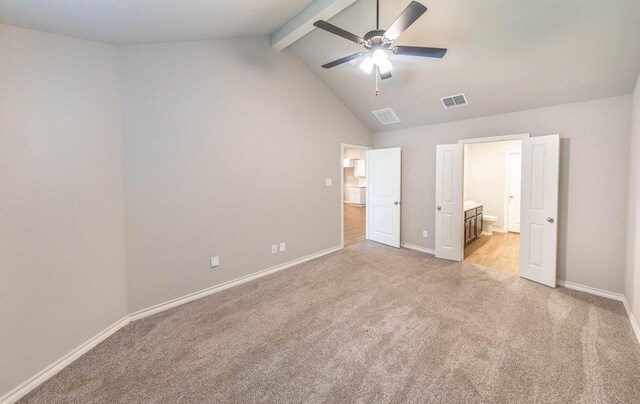 unfurnished bedroom featuring ensuite bath, ceiling fan, beam ceiling, high vaulted ceiling, and light colored carpet