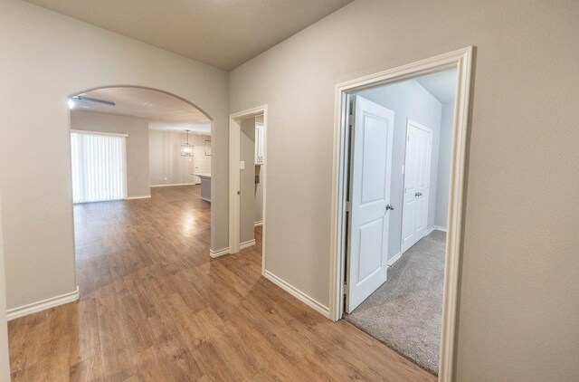 hallway with light hardwood / wood-style floors