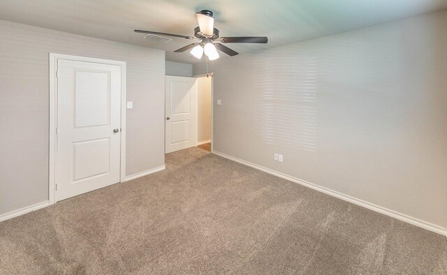 unfurnished bedroom with ceiling fan and carpet