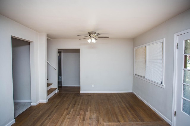 empty room with dark hardwood / wood-style floors and ceiling fan