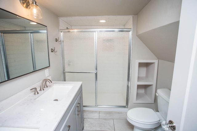 bathroom featuring a shower with door, vanity, tile patterned flooring, and toilet