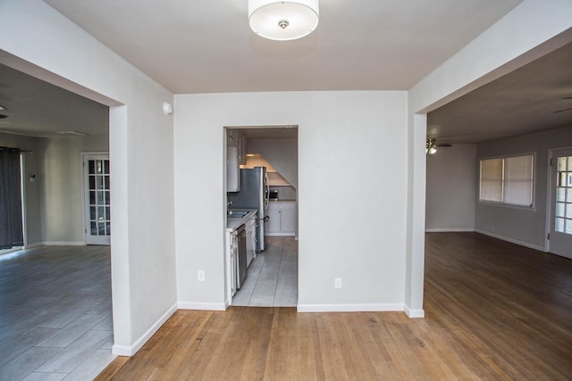 interior space with ceiling fan and light hardwood / wood-style flooring