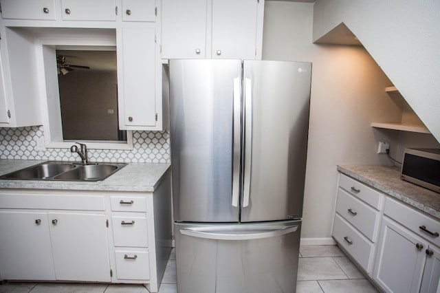 kitchen with stainless steel appliances, sink, and white cabinets