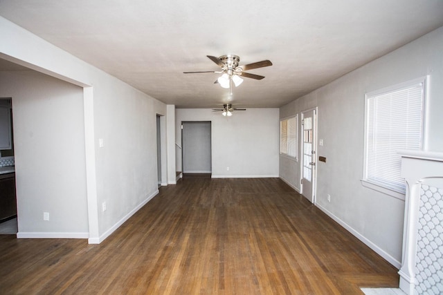 interior space featuring dark wood-type flooring and ceiling fan