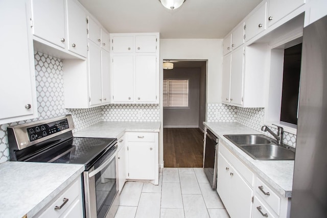 kitchen featuring black dishwasher, sink, stainless steel electric range, and white cabinets