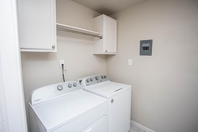 clothes washing area with cabinets and washer and dryer