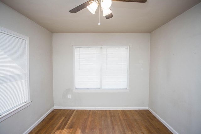 spare room featuring ceiling fan and dark hardwood / wood-style flooring