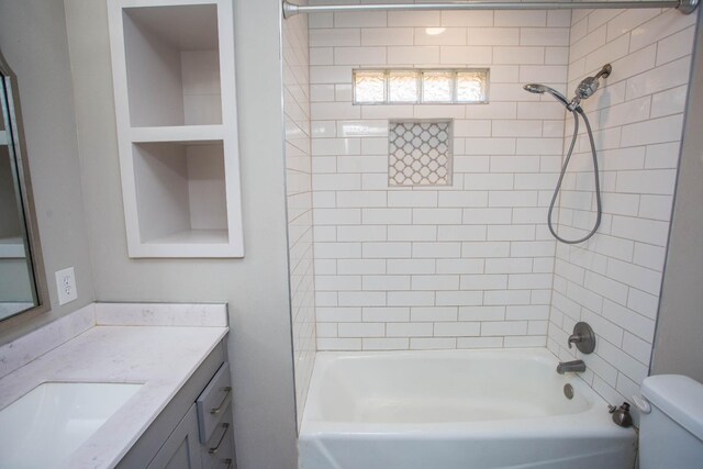 full bathroom with tiled shower / bath combo, vanity, and toilet