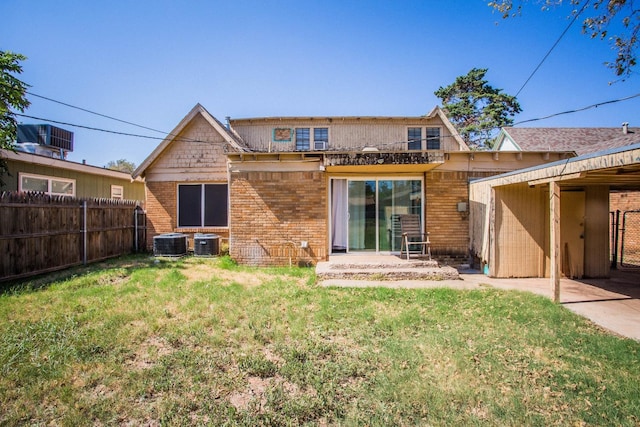 rear view of property featuring a yard and central AC