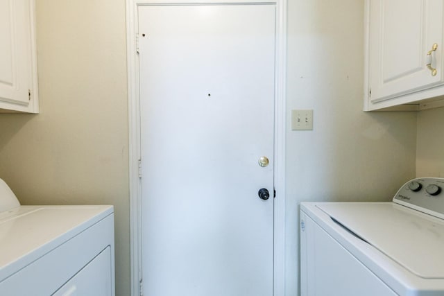 laundry room with cabinets and washer and clothes dryer