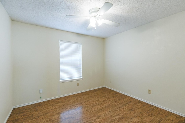 empty room with dark hardwood / wood-style flooring, a textured ceiling, and ceiling fan