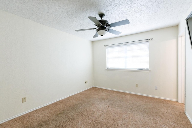 unfurnished room featuring ceiling fan, light colored carpet, and a textured ceiling