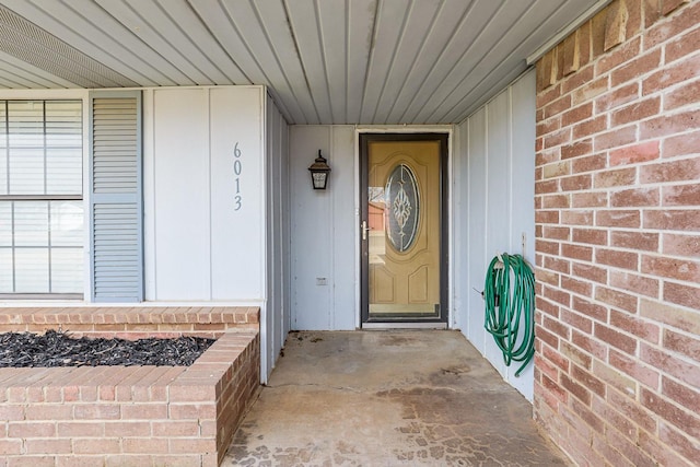 view of exterior entry with brick siding