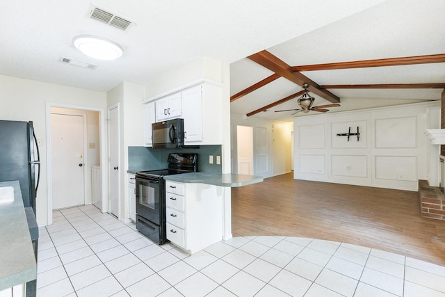 kitchen with light tile patterned floors, visible vents, black appliances, and open floor plan