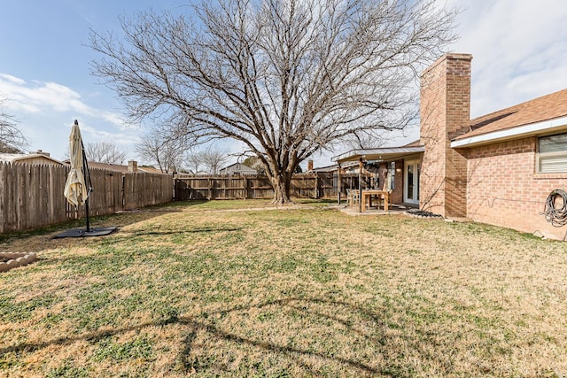 view of yard with a patio and a fenced backyard