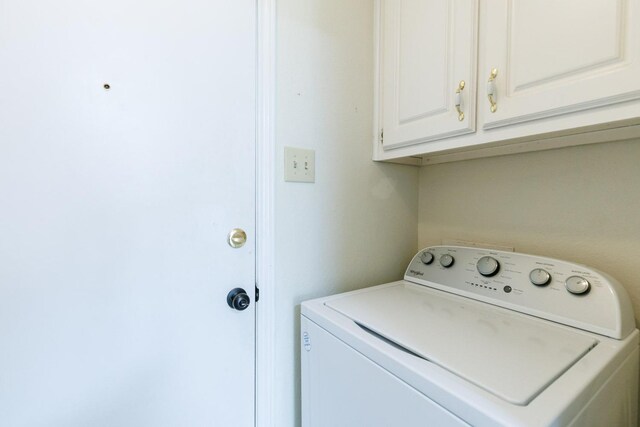 laundry area featuring washer / clothes dryer and cabinets