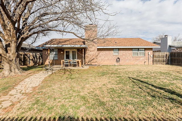 rear view of property featuring a yard and french doors